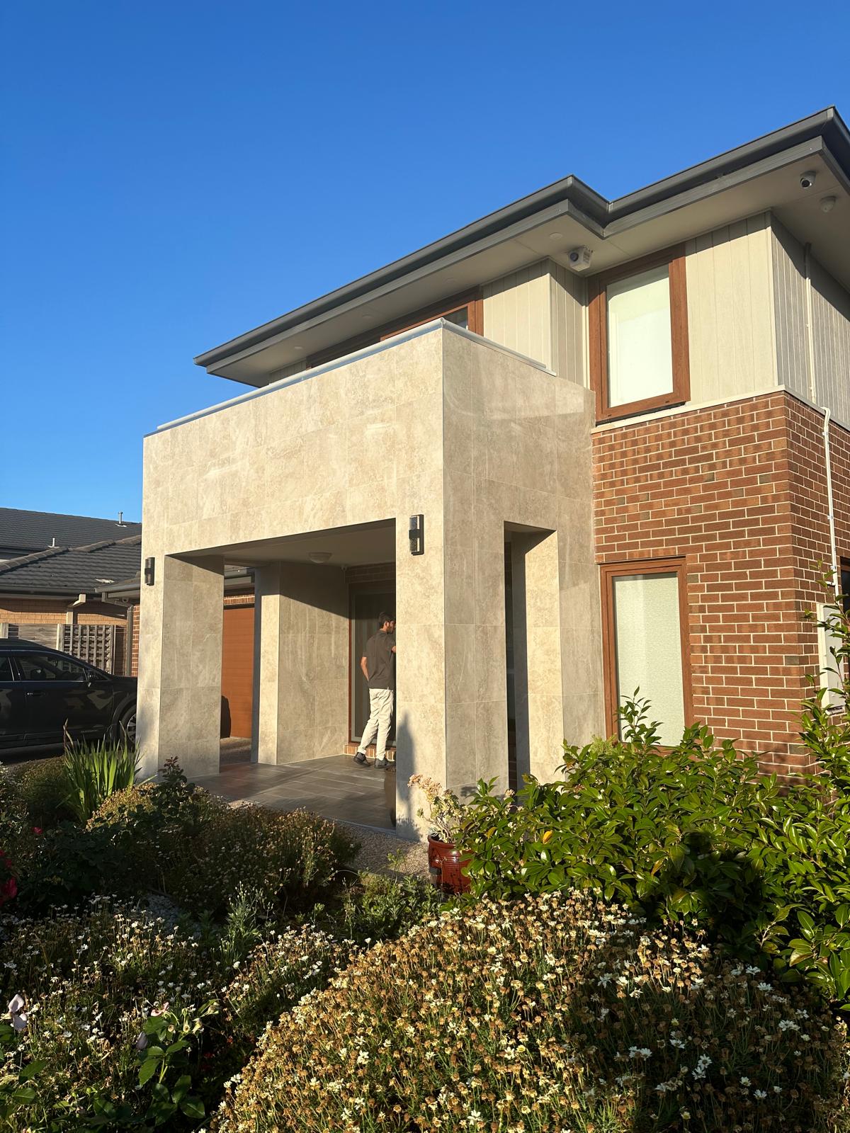 Completed modern entrance with seamless stone tile integration.